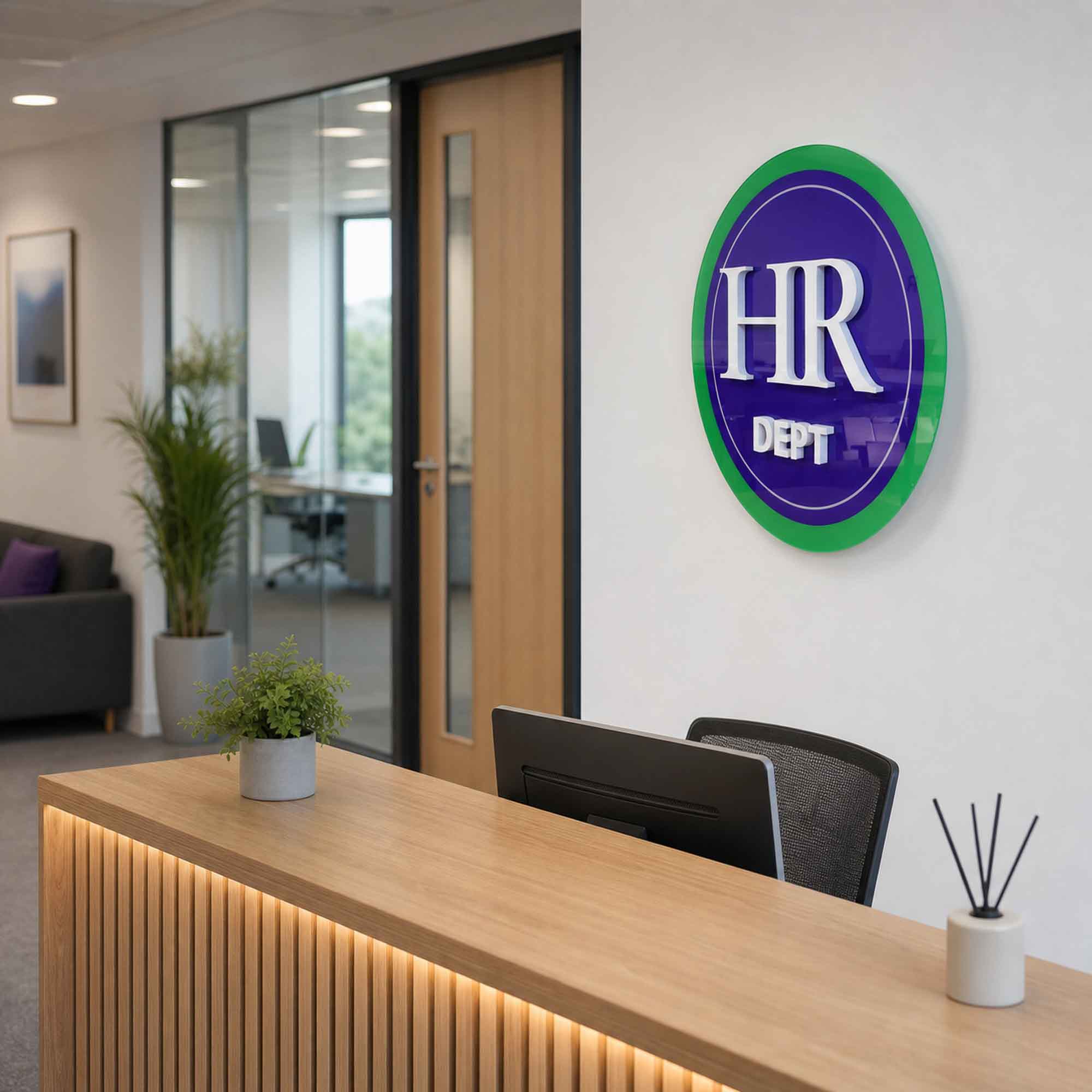 HR Dept plaque displayed in a modern office reception with glass offices and a reception desk.