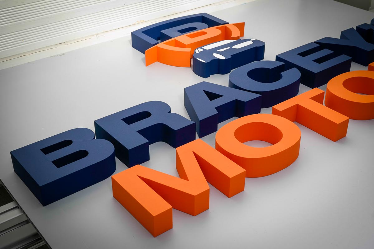 Blue and orange custom 3D business logo letters before installation